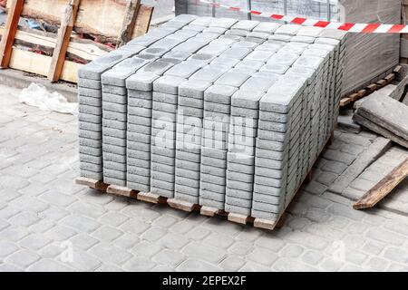new block paving stack at roadside. paving tiles for road repairs Stock Photo