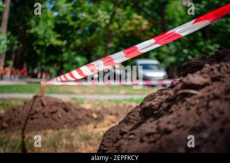 danger red and white striped barrier outdoor. warning and accident concept. soft focus. safety tape Stock Photo
