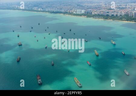 Anchored cargo ships seen from a plane. Singapore. Stock Photo