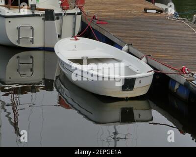St. Petersburg, Russia, July 19 2020 white yachts and dinghy small boat in the marina at the pier Stock Photo