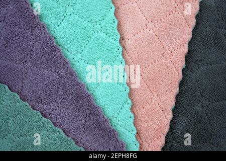 Colored microfibre cloth. stacked colorful microfiber cleaning cloths background. Cleaning wipes close-up top view. Stock Photo