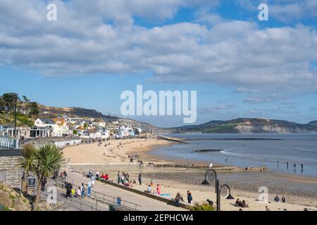 Lyme Regis, Dorset, UK. 27th Feb, 2021. UK Weather: Plenty of people were out and about enjoying unseasonably warm and sunny weather at the seaside resort of Lyme Regis this afternoon. Credit: Celia McMahon/Alamy Live News Stock Photo