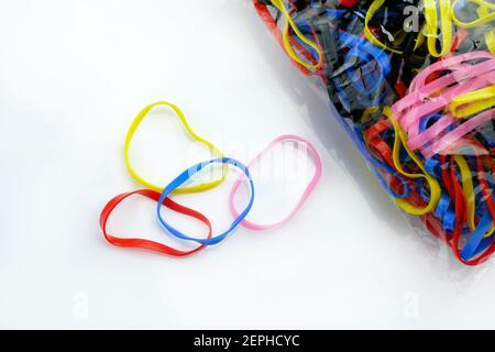 Silicone hair rubber bands on a white background. Multi-colored elastic bands for African braids and other hairstyles. Stock Photo