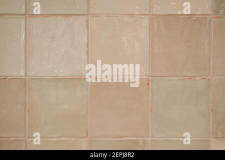 Background from square tiles with a vintage look. The surface is slightly uneven and the hue is a washed-out gray-green Stock Photo