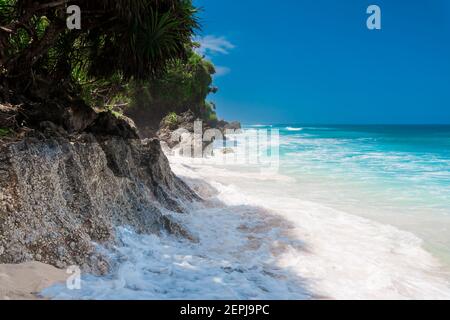 Tropical beach in Bali. Paradise beach and blue ocean with waves Stock Photo