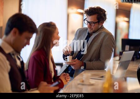 Young business people having a pleasant talk at coffee break in a relaxed atmosphere at the bar. Business, people, bar Stock Photo