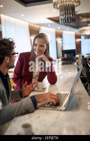 Young business colleagues at the bar enjoying a coffee and talk about job in a relaxed atmosphere. Business, people, bar Stock Photo
