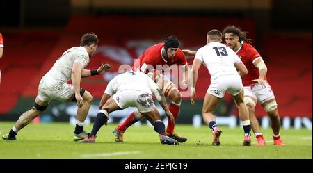 Wales' Adam Beard is tackled by England's Tom Curry (left), Kyle Sinckler (centre) and Henry Slade during the Guinness Six Nations match at the Principality Stadium, Cardiff. Picture date: Saturday February 27, 2021. See PA story RUGBYU Wales. Photo credit should read: David Davies/PA Wire. RESTRICTIONS: Use subject to restrictions. Editorial use only, no commercial use without prior consent from rights holder. Stock Photo