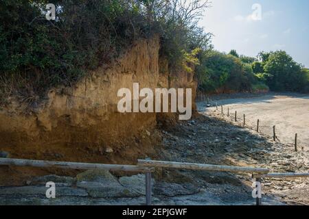 Saint-Brieuc, France - August 27, 2019: A slice of silt cliffs telling the history of the earth for millions of years. Hillion, Saint-Brieuc Bay Natio Stock Photo