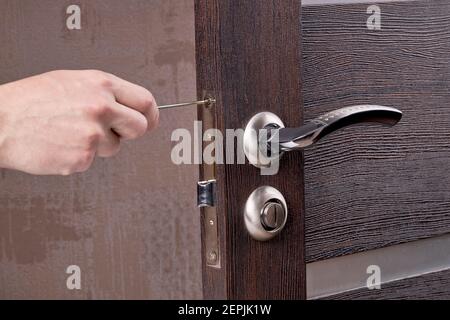 person fixing door furniture using screwdriver. improvement process Stock Photo