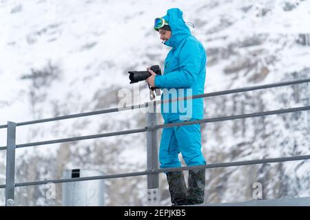 Professional photographer on task in winter wilderness Stock Photo
