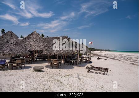 People sat at a beach bar with views out to the Indian ocean, Diani, Kenya, East Africa Stock Photo