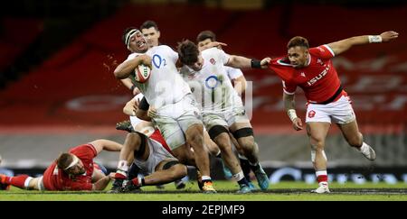 England's Mako Vunipola supported by Tom Curry breaks away during the Guinness Six Nations match at the Principality Stadium, Cardiff. Picture date: Saturday February 27, 2021. See PA story RUGBYU Wales. Photo credit should read: David Davies/PA Wire. RESTRICTIONS: Use subject to restrictions. Editorial use only, no commercial use without prior consent from rights holder. Stock Photo