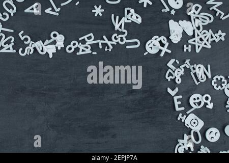 Letter symbols, icons and pins on black background Stock Photo