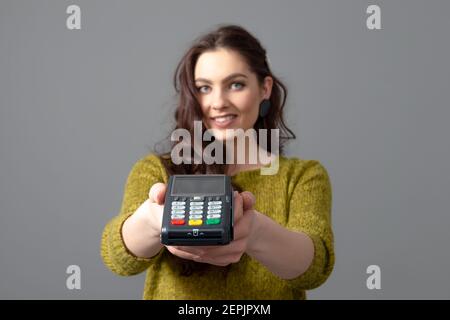 woman holding wireless modern bank payment terminal to process and acquire credit card payments Stock Photo