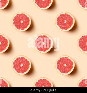 Seamless pattern of grapefruit slice on beige background. Food summer pattern. Stock Photo