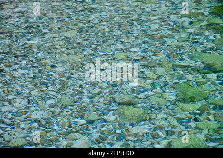 Emerald colored transparent sea water with colorful pebbles in Mali Losinj, Croatia Stock Photo