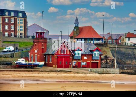 Lifeboat station and old watch tower on the beach at Brown’s Bay, Cullercoats, Tyne and Wear, England Stock Photo
