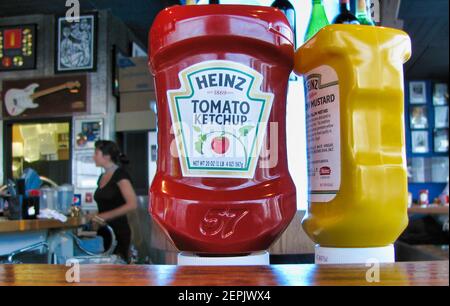 Heinz ketchup and mustards bottles on the counter of a restaurant. Stock Photo