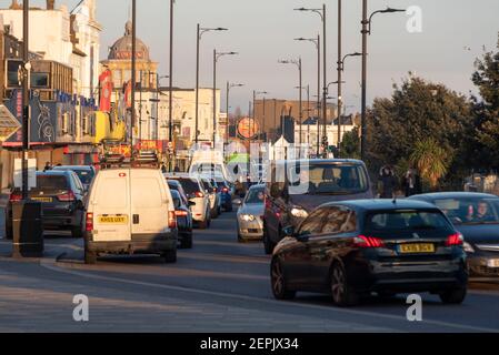 Southend on Sea, Essex, UK. 27th Feb, 2021. The warm sunny weather has attracted visitors to Southend, with the seafront roads especially busy. Traffic queues on Marine Parade passing the closed amusement arcades during the COVID 19 lockdown Stock Photo