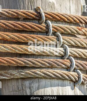 Close up of a braided steel cable wrapped around a post Stock Photo
