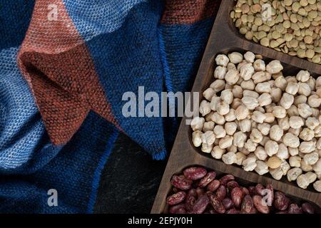 Wooden plates with raw beans on a dark background Stock Photo