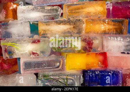 Ice fortress wall build of colored ice blocks or bricks, some with frozen flower inside, in Munkkiniemi district of Helsinki, Finland Stock Photo