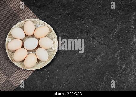 Chicken eggs on ceramic plate. View from above Stock Photo