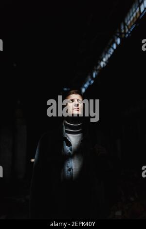 Brutal man on the dark background with place for your text Stock Photo