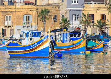 Luzzijiet (Maltese traditional fishing boats) moored in the marina of Marsaxlokk, Malta Stock Photo