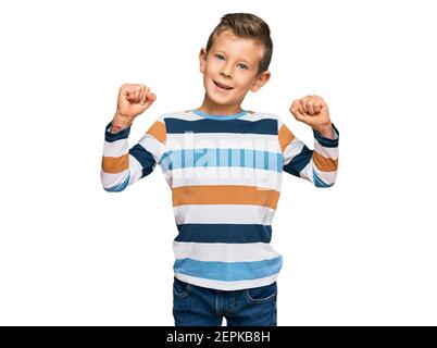 Adorable caucasian kid wearing casual clothes screaming proud, celebrating victory and success very excited with raised arms Stock Photo