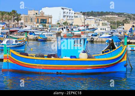 Luzzijiet (Maltese traditional fishing boats) moored in the marina of Marsaxlokk, Malta Stock Photo