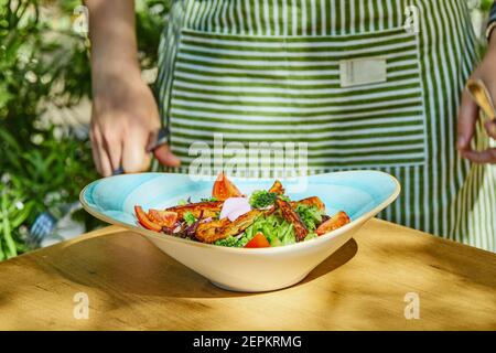 Vegetable and chicken salad in blue bowl Stock Photo