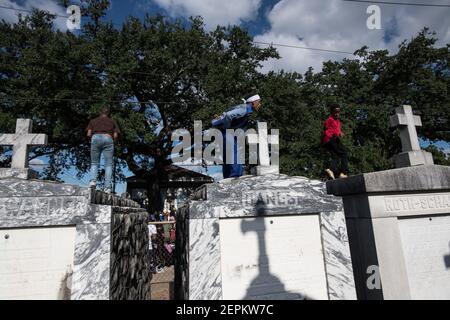 Young men dancing on graves and tombs in cemetery during Prince of Wales, New Orleans Social Aid and Pleasure Club Second Line (Secondline). Stock Photo