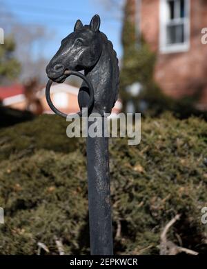 A horse head hitching post mounted in front of an historic home in Santa Fe, New Mexico. Stock Photo