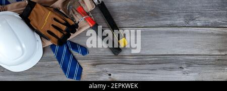 Blue striped necktie with construction labor items on aged wooden planks for Happy Fathers Day concept Stock Photo