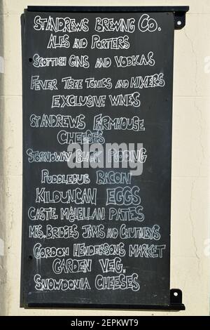 Blackboard outside shop in Crail, Fife, Scotland. Showing a list of local and traditional food and drink produce. Stock Photo