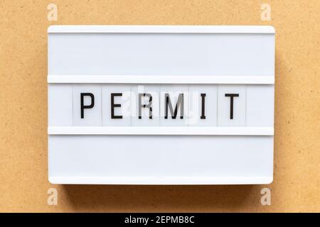 Lightbox with word permit on wood background Stock Photo