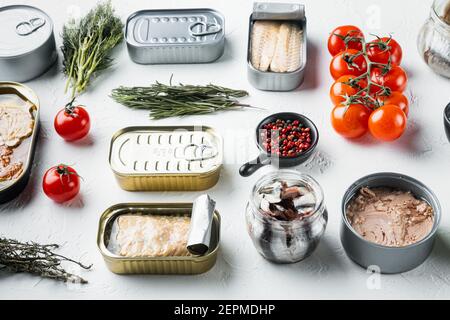 Canned fish with different assortment types of seafood set, on white background with herbs and ingredients Stock Photo