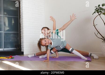 two little girls in sportswear sitting at fitness studio, children sport  concept Stock Photo - Alamy