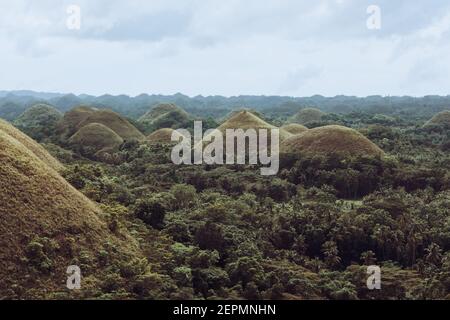 Chocolate Hills with a group of clouds in the sky Stock Photo