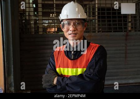 Young factory job worker or engineer close up portrait in manufacturing factory . Industry and engineering concept . Stock Photo