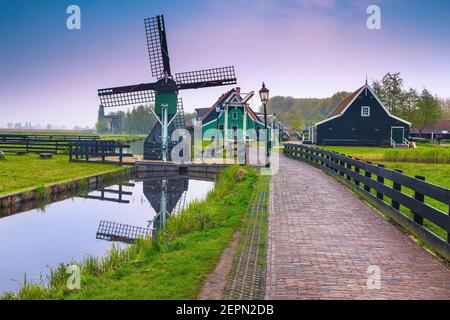 Beautiful dutch countryside street with traditional small wooden windmill, Zaanse Schans touristic village, Netherlands, Europe Stock Photo