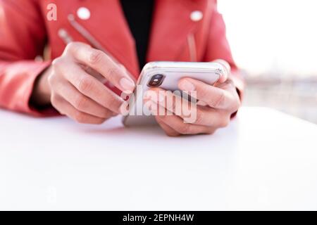 Hands of a black Woman using a mobile phone Stock Photo