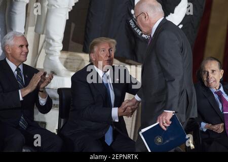 UNITED STATES - JANUARY 17: President Donald Trump, center, greets Sen. Patrick Leahy, D-Vt., during a Congressional Gold Medal ceremony in the Capitol rotunda to honor former Sen. Bob Dole, R-Kan., right, as a 'soldier, legislator, and statesman,' on January 17, 2018. Vice President Mike Pence appears at left. (Photo By Tom Williams/CQ Roll Call)