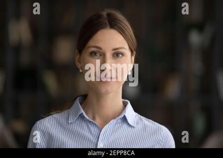 Headshot portrait of smiling young Caucasian woman posing Stock Photo