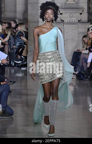 Paris France Jan 6 18 Woman On The Couch Reading Newspaper And Preparing To Unbox The Amazon Prime Parcel Stock Photo Alamy