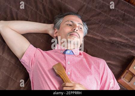 Male model fashion shoot in hotel suite with vintage telephone Stock Photo