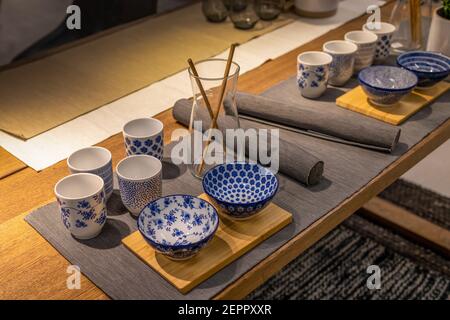 Asian table setting. Blue and withe empty bowls, cups and bamboo chopsticks Stock Photo