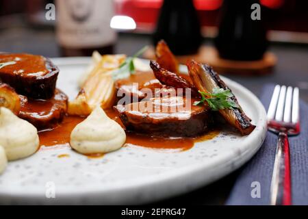 dinner. Meat in gravy with white vegetable puree. Food served on a plate, food styling, serving suggestions, culinary photography. Stock Photo